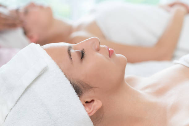 istock Relaxed young woman lying on spa bed for massage. 962081006