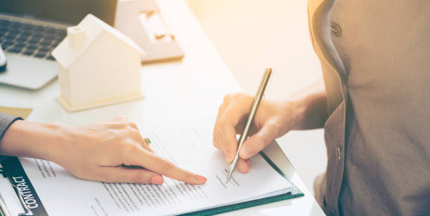 istock Client Signs Document to Buy House and Real Estate 962081040