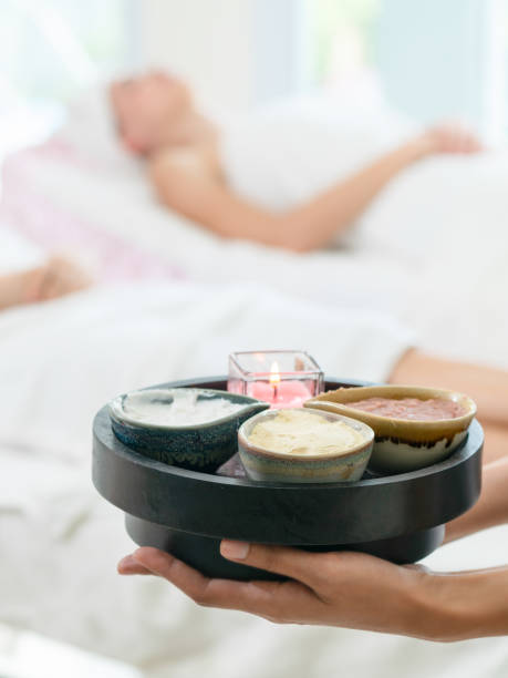 istock Massage therapist with hot spa treatment set. 962081100
