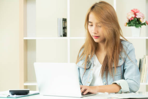 istock Concentrated woman works on computer in home office. 962081114