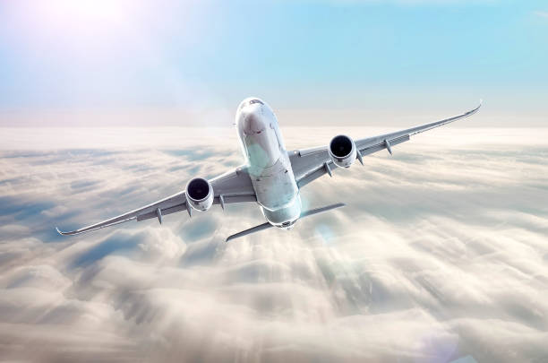 istock Airplane in the sky above the clouds flight journey sun height speed motion blur. 962082102