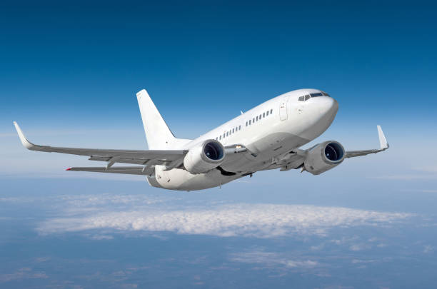 istock Passenger airplane flying at flight level high in the sky above the clouds. 962082132
