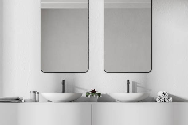 istock Close up of a double sink, vertical mirrors 962086750