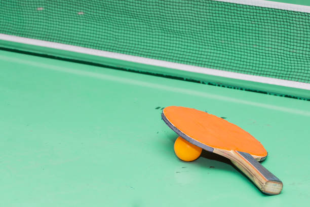 istock Old table tennis rackets on the game table. 962088446