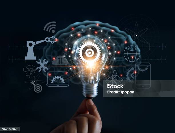 Hand Holding Light Bulb And Cog Inside And Innovation Icon Network Connection On Brain Background Innovative Technology In Science And Industrial Concept Stock Photo - Download Image Now
