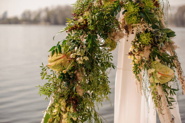 istock Beautiful wedding arch decorated with tropical flowers and white fabric 962093950