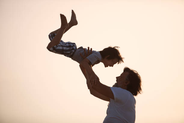 istock Father and son playing at the beach 962094028