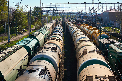Many freight oil cars at the station.