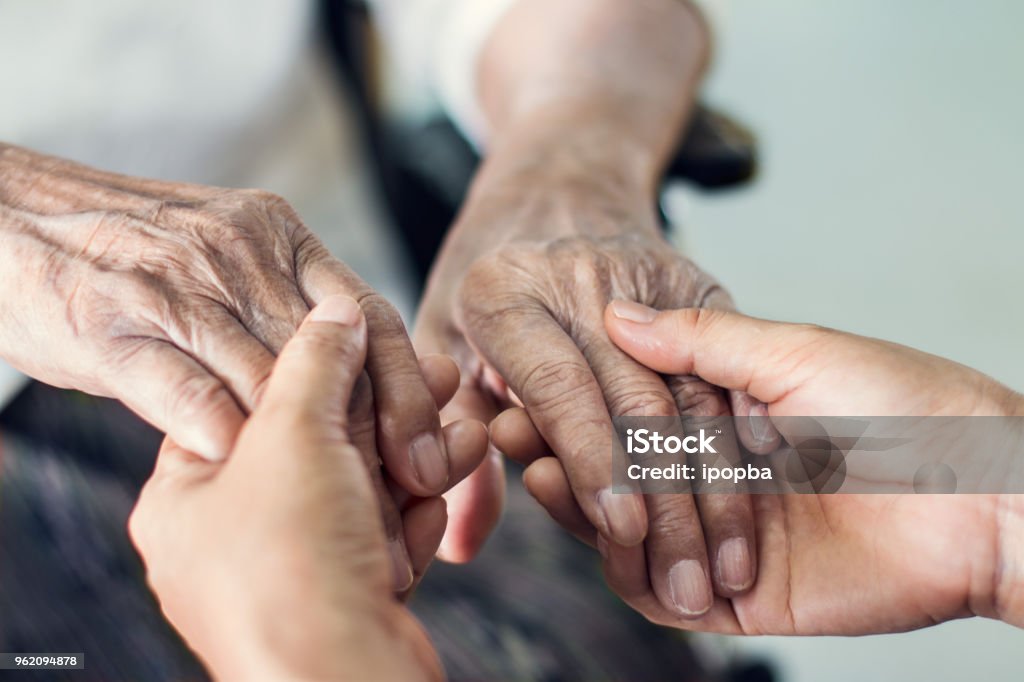 Close up hands of helping hands elderly home care. Mother and daughter. Mental health and elderly care concept Senior Adult Stock Photo