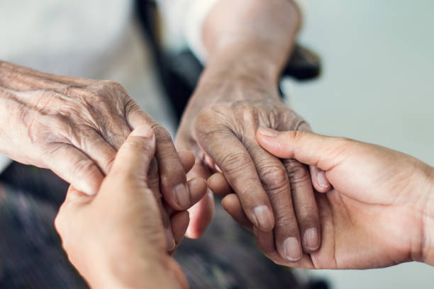 Close up hands of helping hands elderly home care. Mother and daughter. Mental health and elderly care concept Close up hands of helping hands elderly home care. Mother and daughter. Mental health and elderly care concept home caregiver stock pictures, royalty-free photos & images