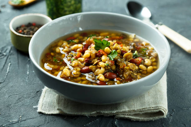 istock Lentils and vegetables soup with pesto sauce 962095302