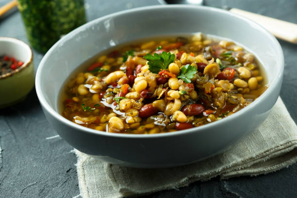 istock Lentils and vegetables soup with pesto sauce 962095626