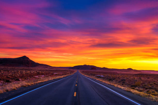 Dramatic sunset over an empty road in Utah Dramatic sunset over an empty road in Utah near its border with Arizona, USA arizona stock pictures, royalty-free photos & images