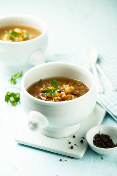 istock Lentils and vegetables soup with pesto sauce 962099670