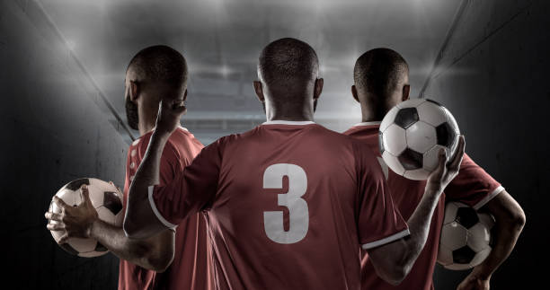 3非洲非白人足球運動員在體育場燈前舉行足球比賽 - man united vs arsenal lineups 個照片及圖片檔