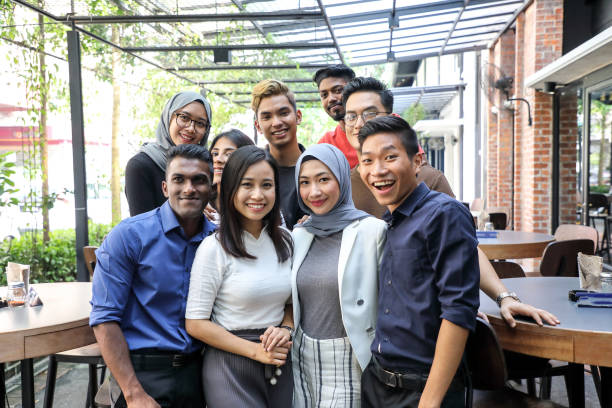 Young Asian man woman group portrait colleague student friend family Young Asian man woman group portrait colleague student friend family east asian ethnicity stock pictures, royalty-free photos & images