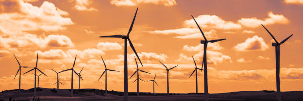 istock Wind turbine field at sunset, dramatic sky 962105670