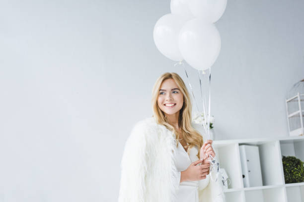 istock girl with white balloons 962106352