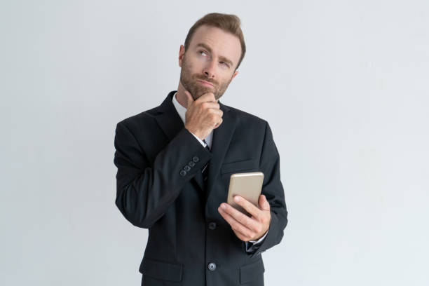 istock Pensive business man touching chin, thinking 962107304