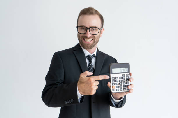 istock Smiling business man holding and showing calculator display 962107338