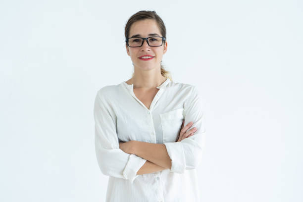istock Smiling young pretty woman looking at camera and standing 962107378
