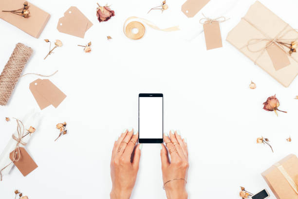 istock Top view female hands holds smart phone with blank screen 962108392