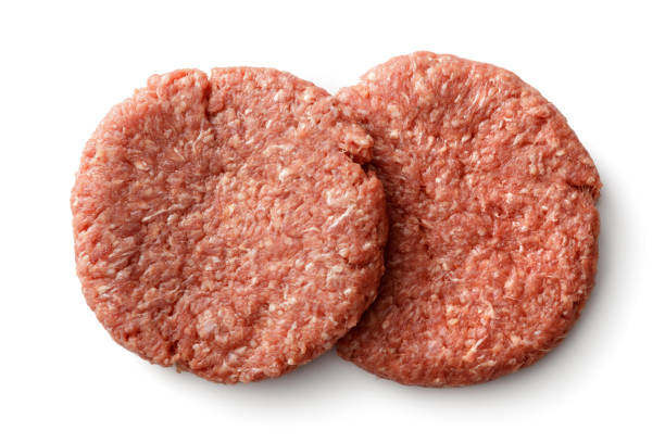 Two roasted burger patties isolated on white background. Clipping path included