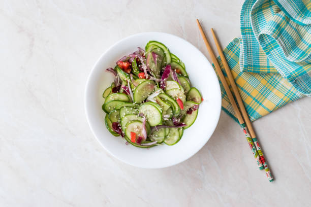 istock Asian Cucumber Salad with Sesame and served with Chopsticks. 962113032