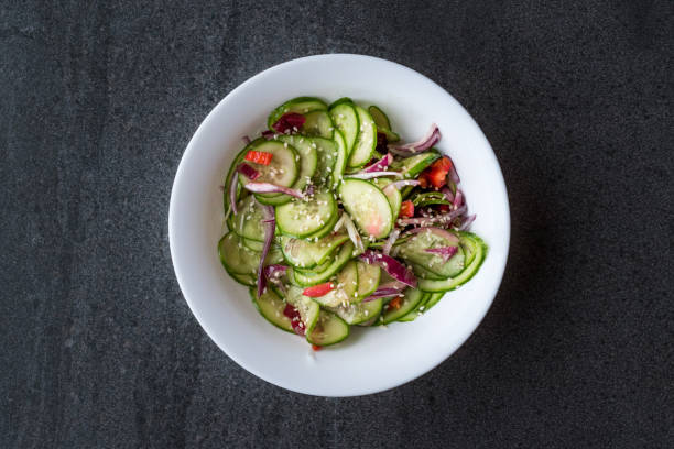 istock Asian Cucumber Salad with Sesame and served with Chopsticks. 962113196
