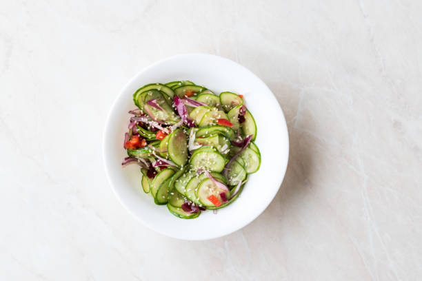 istock Asian Cucumber Salad with Sesame and served with Chopsticks. 962113342
