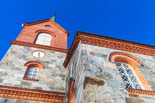 Facade of Juva Church under blue sky in summer day. Finland