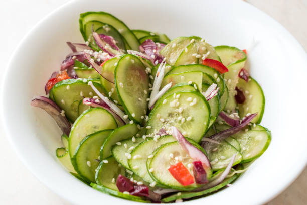 istock Asian Cucumber Salad with Sesame and served with Chopsticks. 962113536