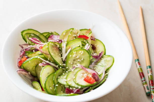 istock Asian Cucumber Salad with Sesame and served with Chopsticks. 962113680