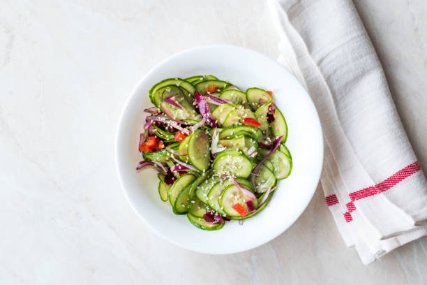 istock Asian Cucumber Salad with Sesame and served with Chopsticks. 962113872