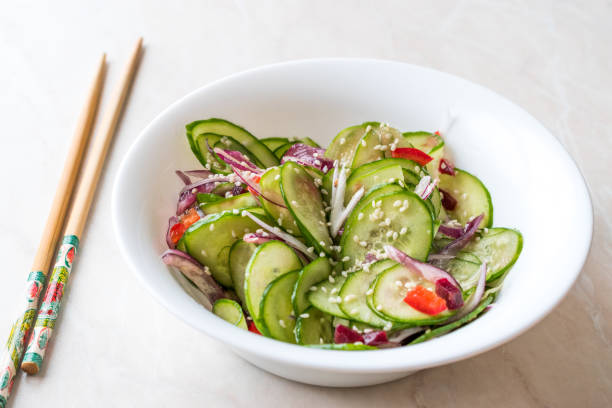 istock Asian Cucumber Salad with Sesame and served with Chopsticks. 962113978