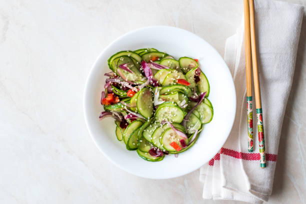 istock Asian Cucumber Salad with Sesame and served with Chopsticks. 962114090