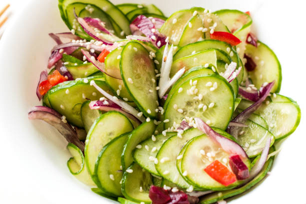 istock Asian Cucumber Salad with Sesame and served with Chopsticks. 962114320