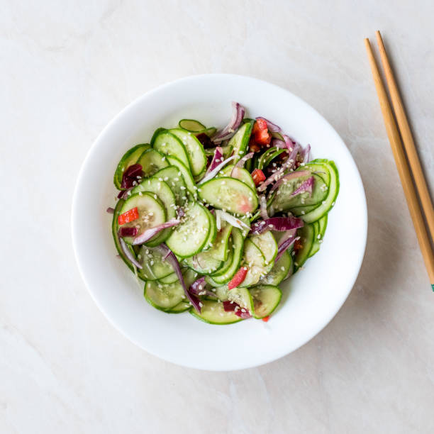 istock Asian Cucumber Salad with Sesame and served with Chopsticks. 962114392