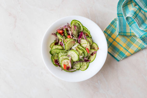 istock Asian Cucumber Salad with Sesame and served with Chopsticks. 962114602