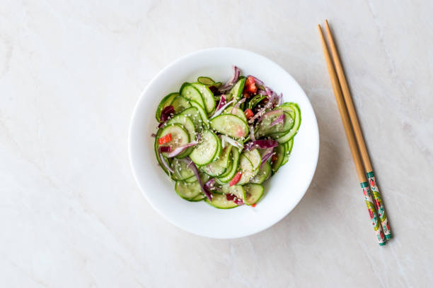 istock Asian Cucumber Salad with Sesame and served with Chopsticks. 962117264
