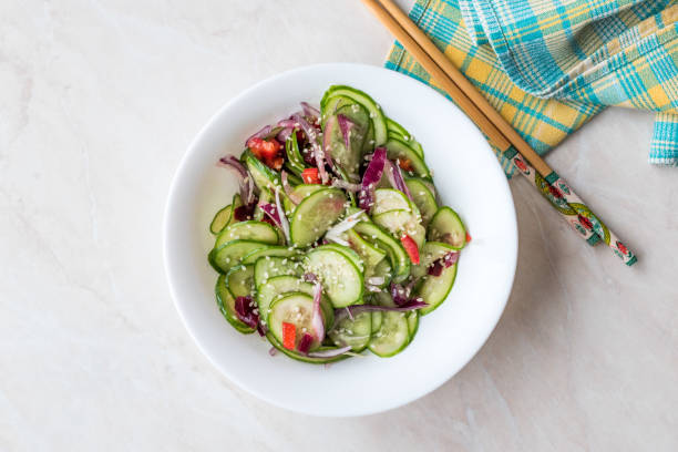 istock Asian Cucumber Salad with Sesame and served with Chopsticks. 962117360