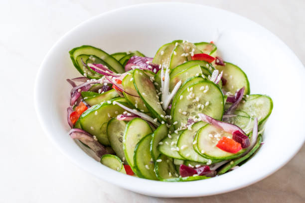 istock Asian Cucumber Salad with Sesame and served with Chopsticks. 962117602