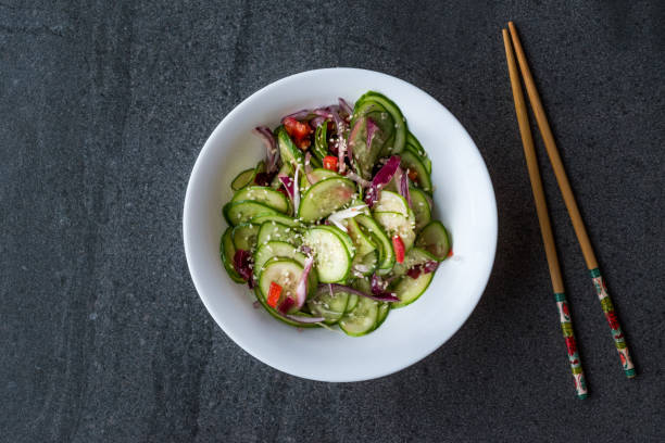 istock Asian Cucumber Salad with Sesame and served with Chopsticks. 962117812