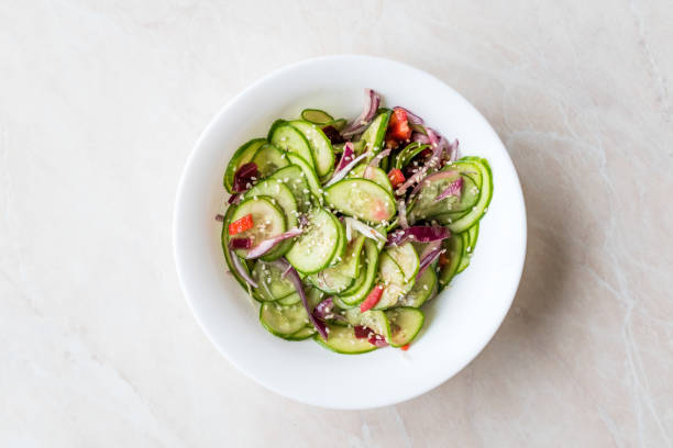 istock Asian Cucumber Salad with Sesame and served with Chopsticks. 962117940