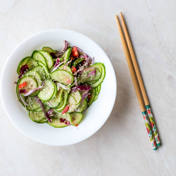 istock Asian Cucumber Salad with Sesame and served with Chopsticks. 962118014