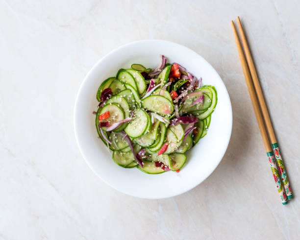 Asian Cucumber Salad with Sesame and served with Chopsticks.