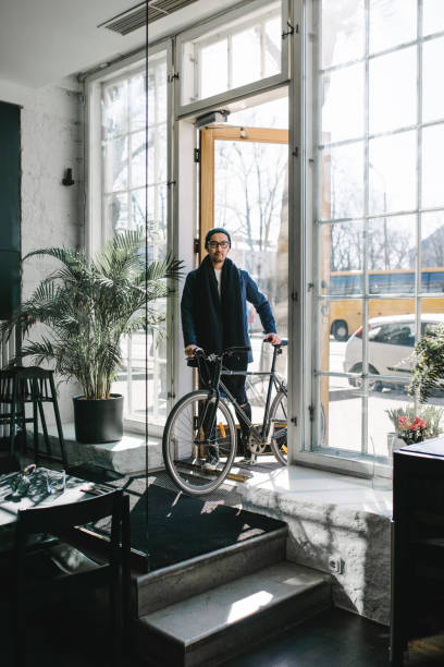 Asian commuter series where cafe owner is coming to work with a bike.