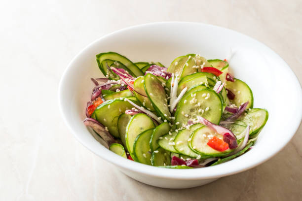 istock Asian Cucumber Salad with Sesame and served with Chopsticks. 962118302
