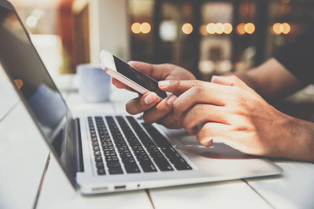 istock Close up hand of  businessman using cellphone for connecting and work with laptop 962118894