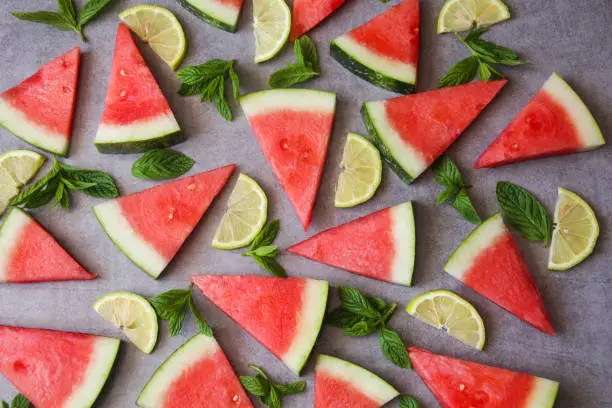 Watermelon , Lemon slices and green mint leaves on grey background. Top view, flat lay. summer, freshness concept